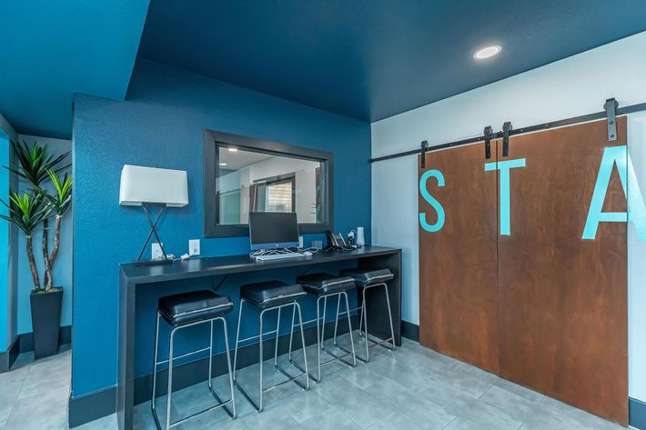a blue and white office with a bar and a sign that says sta at The Starburst Apartments