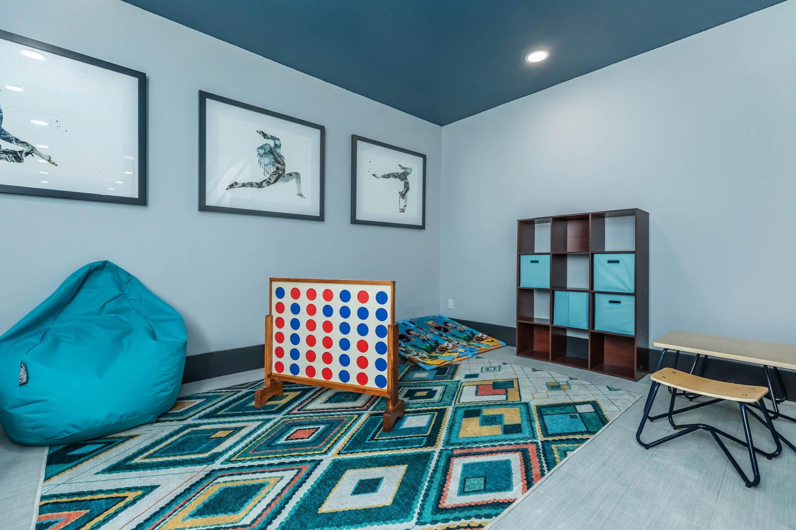 a play room with blue walls and a blue rug at The Starburst Apartments